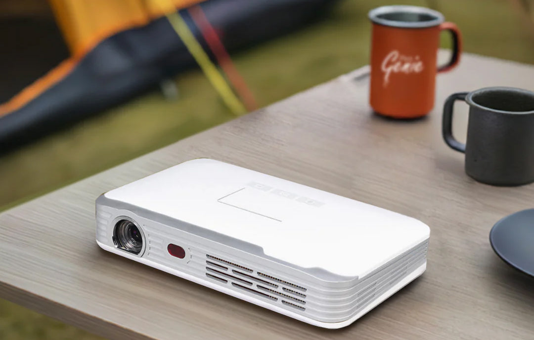 Pico Genie M550 Plus 3.0 Portable Projector on a camping table outdoors